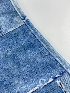 Close-up of blue and white mottled fabric showing double needle stitching and hem details