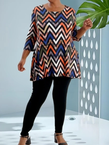 Women's plus size casual long sleeve top with vibrant chevron print and black leggings
