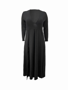 Detail view of black long-sleeve V-neck dress featuring high waist and pleated skirt design