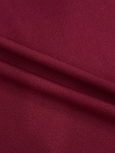 Macro shot of high-quality wine red knitted fabric texture with soft drapes and fine weave