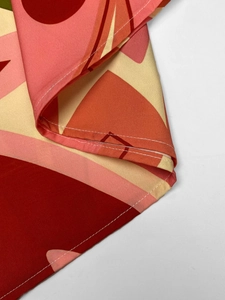 Close-up of fine stitching and abstract geometric print on long sleeve dress fabric