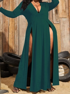 Detail of elegant dark green maxi dress with deep V-neck and high leg slit design