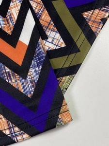 Macro view of geometric V-pattern print and double-needle stitching on casual top