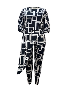 Detail of two-piece set featuring black and white geometric print and asymmetric hemline