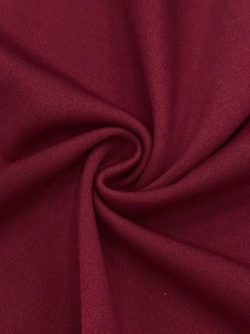 Detailed macro view of the soft burgundy knit fabric texture with ribbed patterns