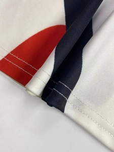 Detail of color-block dress fabric with precise double-needle stitching and smooth hem
