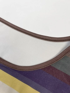 Detailed close-up of crew neck edge and colorful striped knit fabric on a slim dress