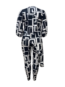 Detailed back view of a slim-fit jumpsuit with black and white geometric print