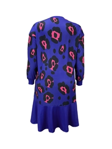 Detail of royal blue long sleeve floral dress featuring ruffled fishtail hem and elastic cuffs