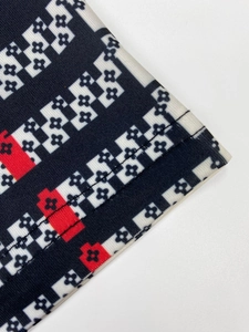 Detailed close-up of geometric pattern fabric with precise double-needle stitching