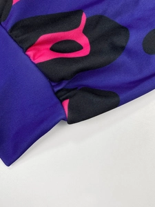 Detail of purple leopard print sleeve cuff and high-quality knitted fabric texture