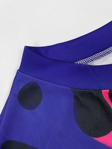 Detail of navy blue knit fabric with black polka dots and pink accents for a maxi dress