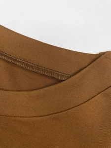 Detail of high-density brown knitted fabric and precision round neck stitching
