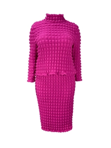 Detail of rose pink popcorn fabric texture on a long-sleeve top and skirt set