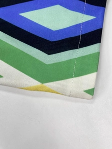 Close-up of geometric pattern print and neat stitching on long-sleeve blazer fabric