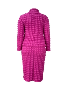 Detail of rose red two-piece set featuring textured popcorn fabric and long sleeves