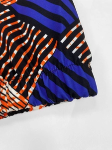 Close-up of geometric striped print fabric with elastic hem detail and precise stitching