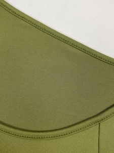 Close-up of grass green knitted dress featuring precision double-needle stitching and texture