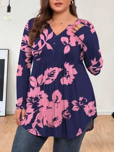 Detail of dark blue V-neck long sleeve blouse featuring pink floral prints and buttons