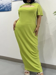 Detail of lime green ribbed knit dress with cut-out chest and sleek slim-fit texture