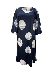 Detail of V-neck neckline on navy blue midi dress with white polka dot patterns