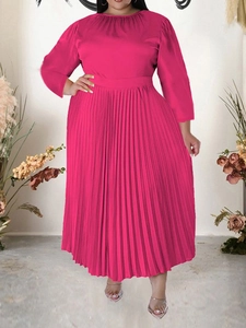 Detail of the elegant waist design and pleated hemline on this magenta long sleeve dress