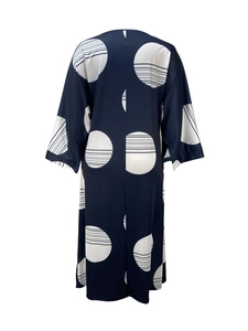 Detail view of the deep blue long-sleeve dress featuring bold white geometric dot patterns