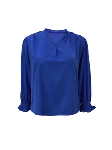 Detail of royal blue V-neck top showing pleated neckline and puff sleeves with ruffled cuffs