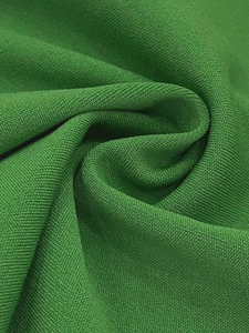 Détail de la texture macro du tissu en maille nid d'abeille vert herbe premium
