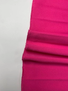 Detailed view of magenta fabric texture with high-quality stitching and plain weave finish