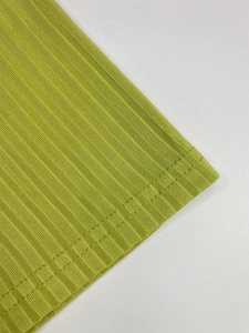 Close-up of avocado green ribbed knit fabric hem with neat double-needle stitching details