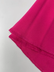 Macro view of rose red pique knit fabric texture and high-quality double-stitch hem sewing
