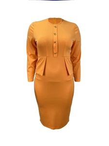 Detail view of ginger yellow dress featuring golden metal buttons and peplum waist structure
