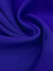 Macro view of dark purple knit fabric with honeycomb texture and soft drape detail
