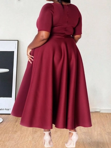 Detail view of wine red A-line dress back with invisible zipper and smooth fabric texture