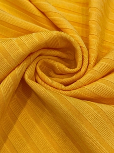 Detailed macro shot of the mango yellow rib knit fabric texture with vertical stripe patterns