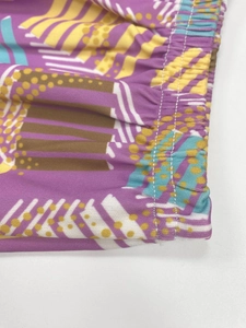 Close-up of elastic waistband with double-needle stitching and geometric abstract print
