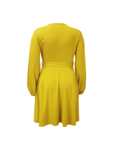 Back view of a ginger yellow long-sleeve dress featuring pleated hem and waist belt