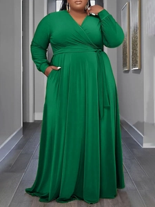 Detail of elegant dark green plus size maxi dress with wrap V-neck and waist tie design