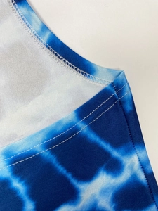 Detail of blue and white tie-dye print dress with double needle stitching and seam finish