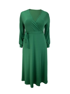 Detail of elegant dark green wrap dress featuring V-neckline and adjustable waist tie