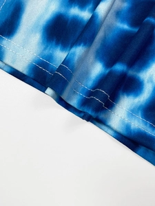 Detail of blue tie-dye knit dress featuring high-quality double-needle flat sewing hem