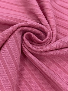 Detail of pink rib knit fabric showing vertical striped texture and soft material