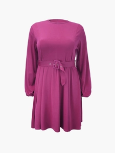 Detail of elegant magenta long sleeve dress with waist belt and pleated skirt design