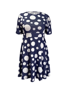 Dettaglio dell'abito blu navy a pois con elegante scollo a girocollo e maniche corte
