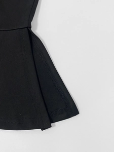 Detailed close-up showing the side slit design and reinforced stitching on black cotton dress