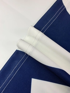 Detail of professional double-needle stitching on breathable blue and white mesh fabric