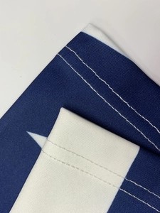 Close-up of double-stitched seams on durable blue and white star-patterned fabric