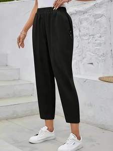 Women's black high-waisted cropped trousers with elastic waist and side decorative buttons