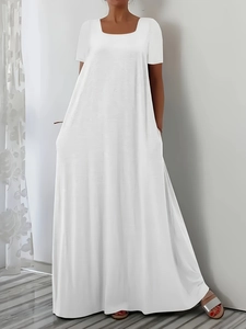 Elegant white short sleeve maxi dress with round neck and pockets for a casual summer look